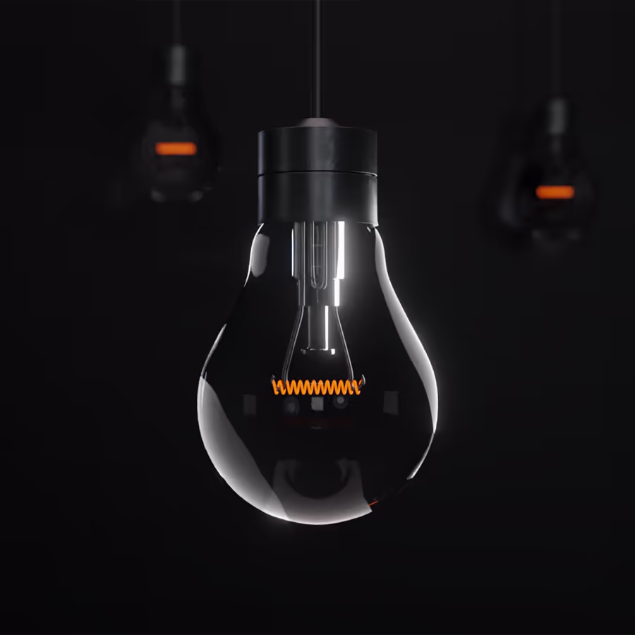 Черная лампа Эдисона с нитью накаливания висящая в темноте